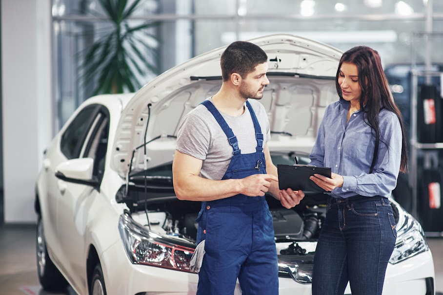 A man mechanic and woman customer discussing repairs done to her vehicle. Car Consulting Australia Sydney