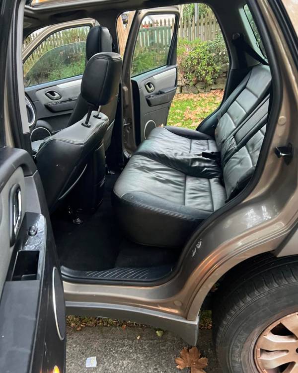 Front view of a Mazda's interior, showing worn leather seats after a Mobile Car Detailing